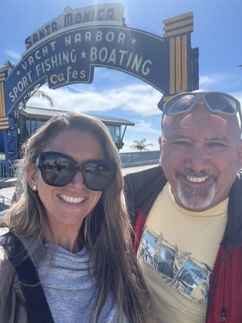 Kim Weisenberg and her father share a moment at the Santa Monica pier during her trip to California to appear on the TV game show Wheel of Fortune.