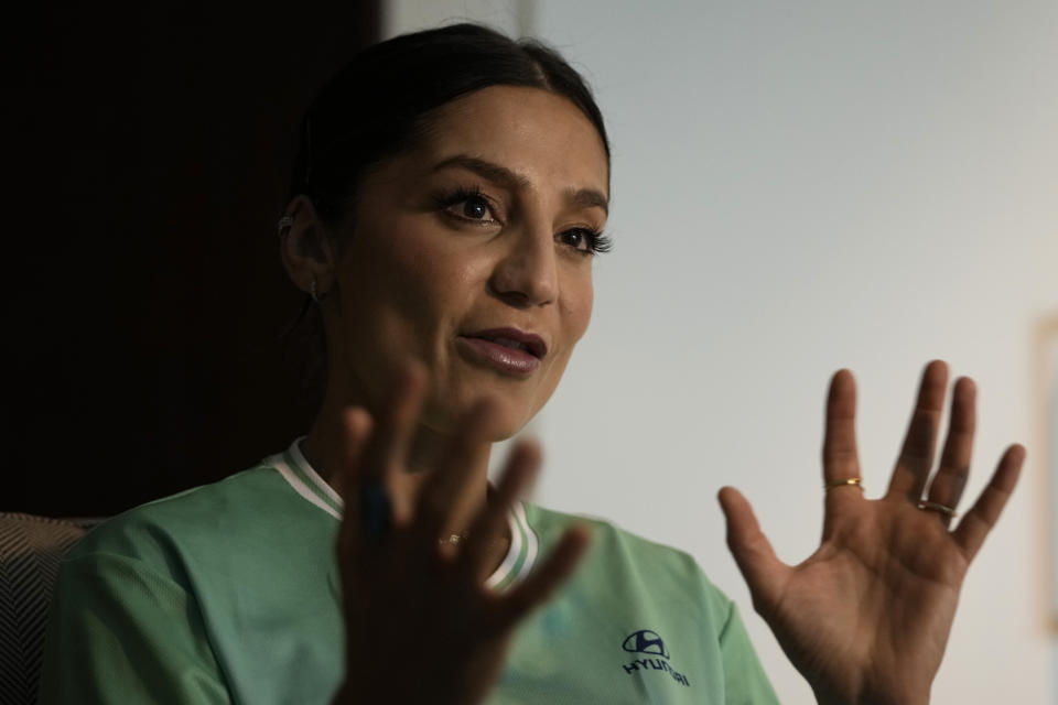 Nadia Nadim gestures as she speaks during an interview with The Associated Press in Doha, Qatar, Thursday, Dec. 1, 2022. Danish women's national team player Nadia Nadim was about to settle in for her job as a television commentator at the World Cup when she was shaken by tragic news: Her mother, who had helped the family flee the Taliban when Nadim was just a girl, had been hit by a car while rushing home to watch her daughter on TV. (AP Photo/Hassan Ammar)