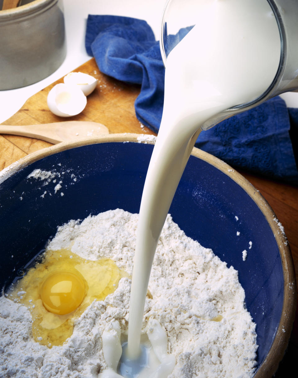 Adding milk to flour and egg