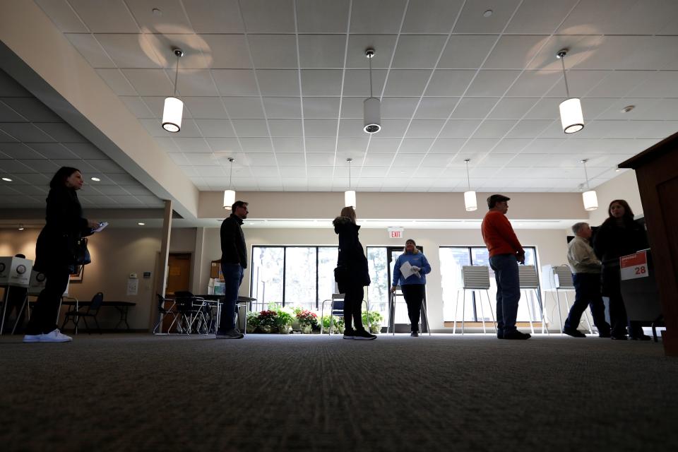 Evanston residents line up for voting at Trinity Lutheran Church in Evanston, Ill., Tuesday, March 17, 2020. Some polling places in Evanston have been moved in an effort to reduce exposure of senior citizens to the COVID-19 coronavirus.(AP Photo/Nam Y. Huh) ORG XMIT: ILNH106