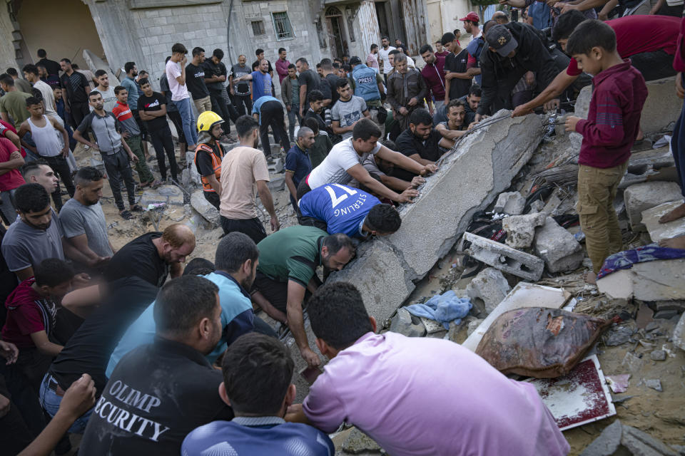 Palestinians look for survivors after Israeli airstrikes in Khan Younis, Gaza Strip, Monday, Oct. 16, 2023. (AP Photo/Fatima Shbair)