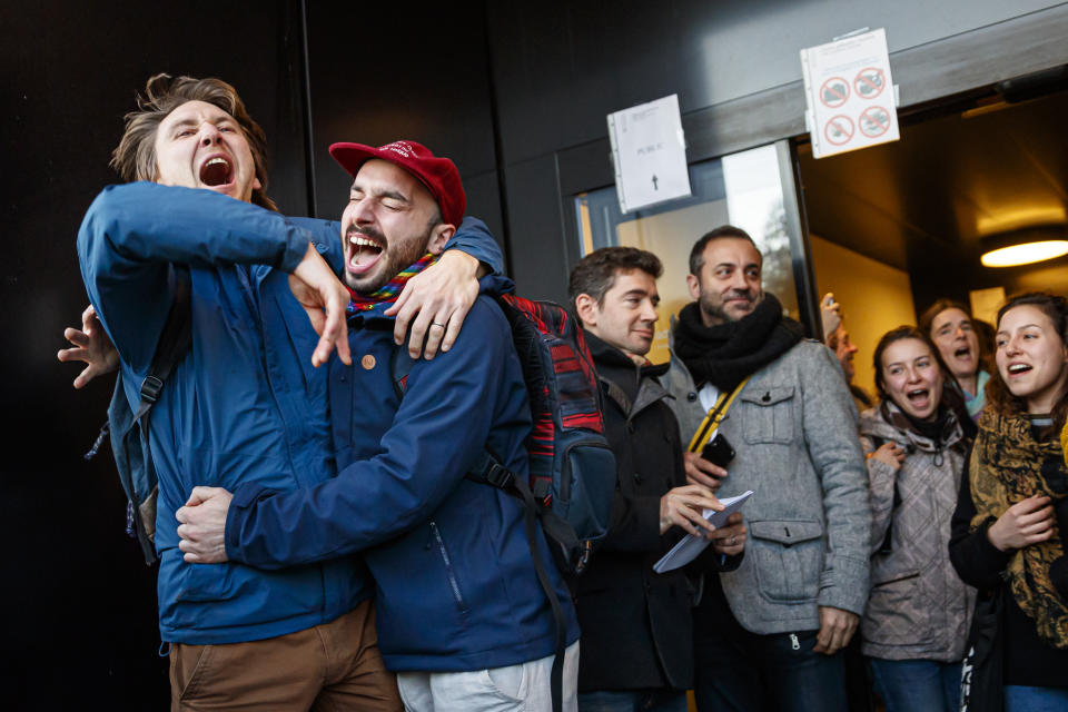 People celebrate the not guilty verdict of the trial of 12 pro-climate activists of the LAC collective (Lausanne Action Climat) , in front of the tribunal of Renens, Switzerland, Monday, Jan. 13, 2020. A Swiss court on Monday threw out a case against a dozen climate activists who were on trial for storming a Credit Suisse office in Lausanne, Switzerland, and playing tennis inside — part of a protest against the bank’s investments in fossil fuels that has ensnared its brand ambassador Roger Federer. (Valentin Flauraud/Keystone via AP)