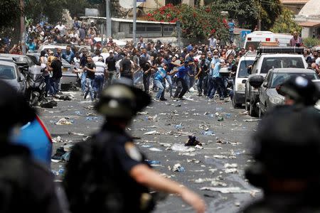 Palestinians clash with Israeli security forces outside Jerusalem's Old city. REUTERS/Ronen Zvulun