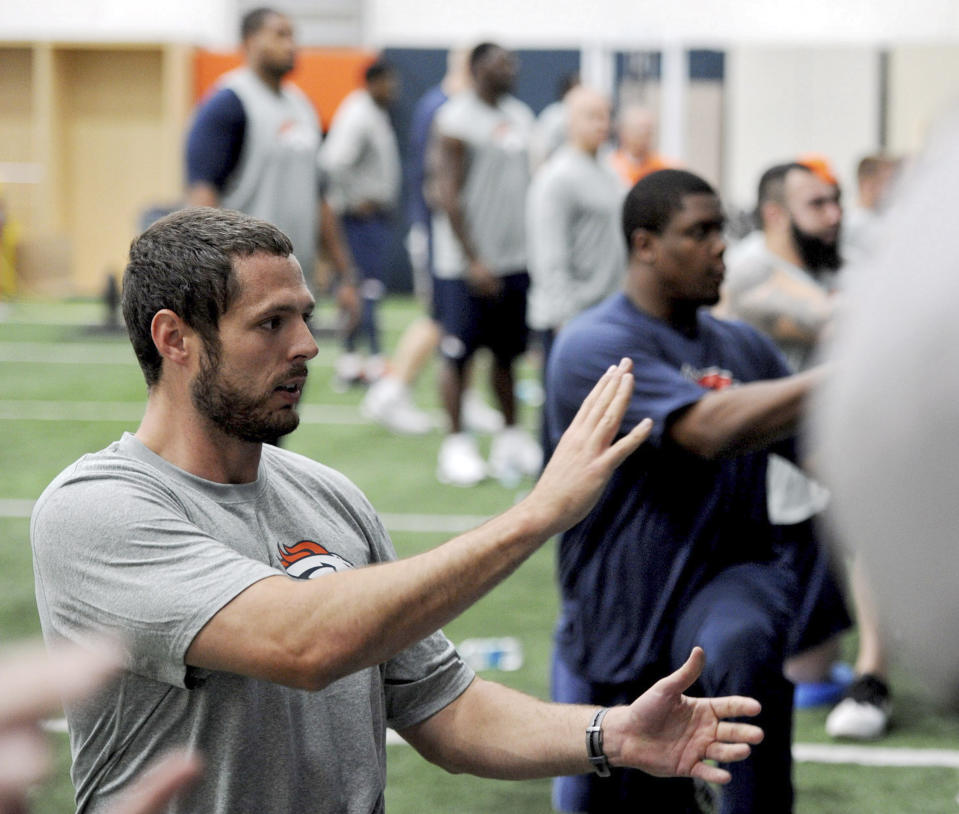 In this photo provided by the Denver Broncos, players workout at the NFL football teams training facility in Englewood, Colo., on Monday, April 21, 2014. (AP Photo/Denver Broncos, Eric Lars Bakke)