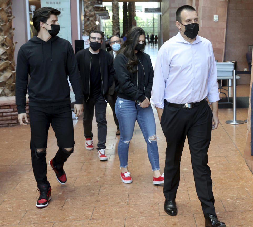 The family of victim Tina O. Tintor walk out of the Regional Justice Center in Las Vegas, Wednesday, Nov. 3, 2021, after the initial court appearance of former Raiders wide receiver Henry Ruggs III in connection with a fiery crash that left the 23-year-old woman dead. Tintor died with her dog in a wrecked and burned Toyota Rav4, according to police. Records show she lived several blocks from where the crash occurred. (K.M. Cannon/Las Vegas Review-Journal via AP)