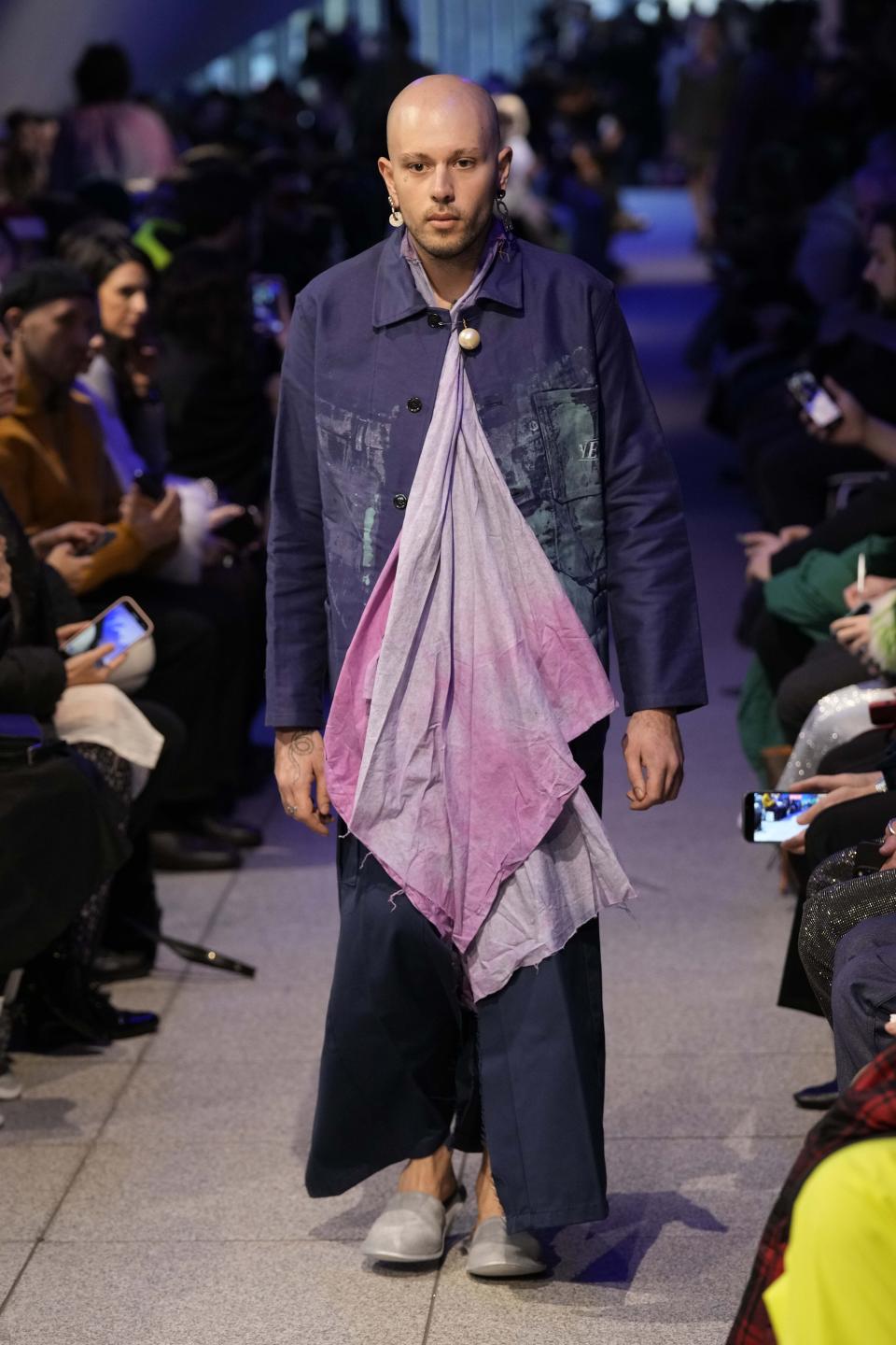 A model wears a creation part of the men's Simon Cracker Fall-Winter 2024-2025 collection, that was presented in Milan, Italy, Sunday, Jan. 14, 2024. (AP Photo/Antonio Calanni).