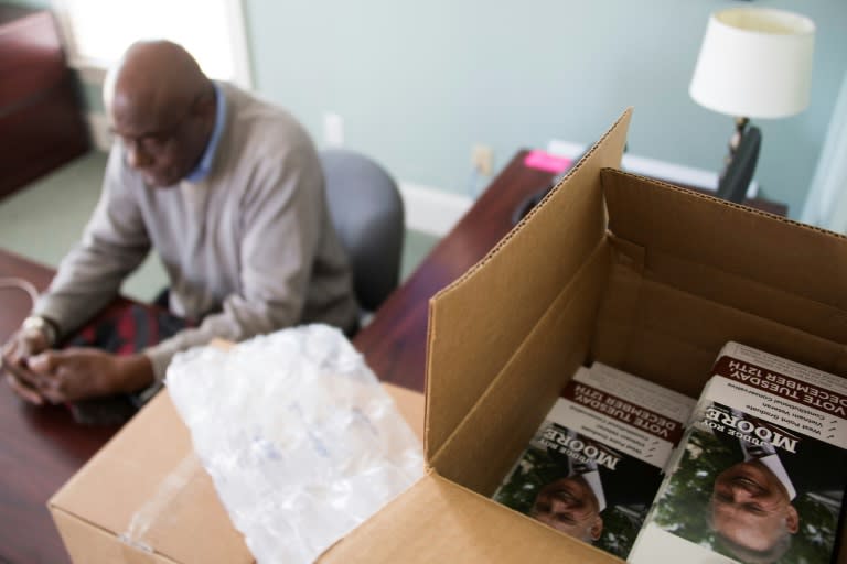 Stacks of pamphlets for Republican Senate candidate Roy Moore sit on a desk as volunteer Willie Casey makes phones calls from the Alabama Republican Party headquarters in Birmingham