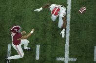 Alabama's Bryce Young thorws past Georgia's Channing Tindall during the first half of the College Football Playoff championship football game Monday, Jan. 10, 2022, in Indianapolis. (AP Photo/Charlie Riedel)