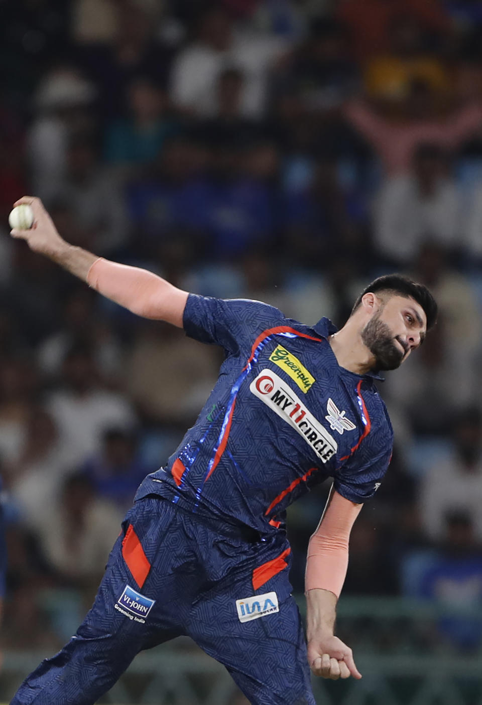 Lucknow Super Giants' Naveen-ul-Haq bowls a delivery during the Indian Premier League cricket match between Lucknow Super Giants and Delhi Capitals in Lucknow, India, Friday, April 12, 2024. (AP Photo/Surjeet Yadav)