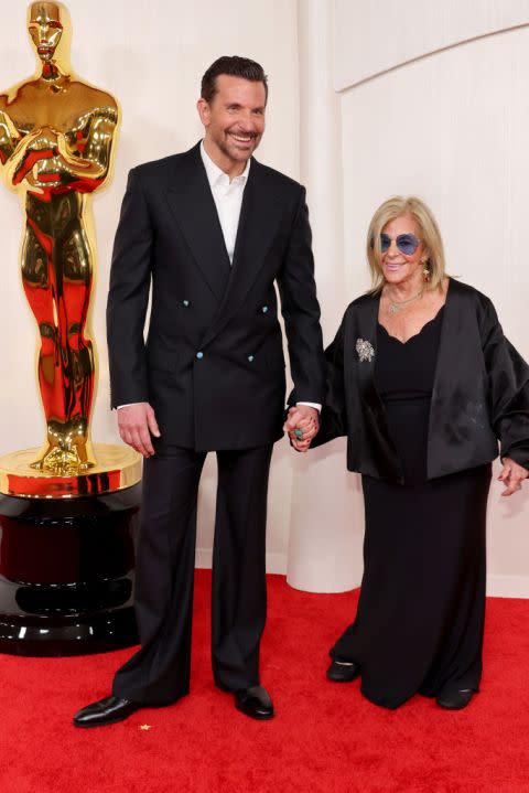 HOLLYWOOD, CALIFORNIA – MARCH 10: (L-R) Bradley Cooper and Gloria Campano attend the 96th Annual Academy Awards on March 10, 2024 in Hollywood, California. (Photo by Mike Coppola/Getty Images)