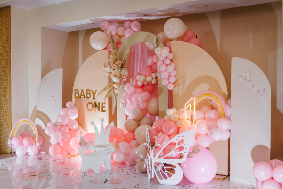 A baby shower decor with balloons, butterfly, and "BABY" sign, no people visible