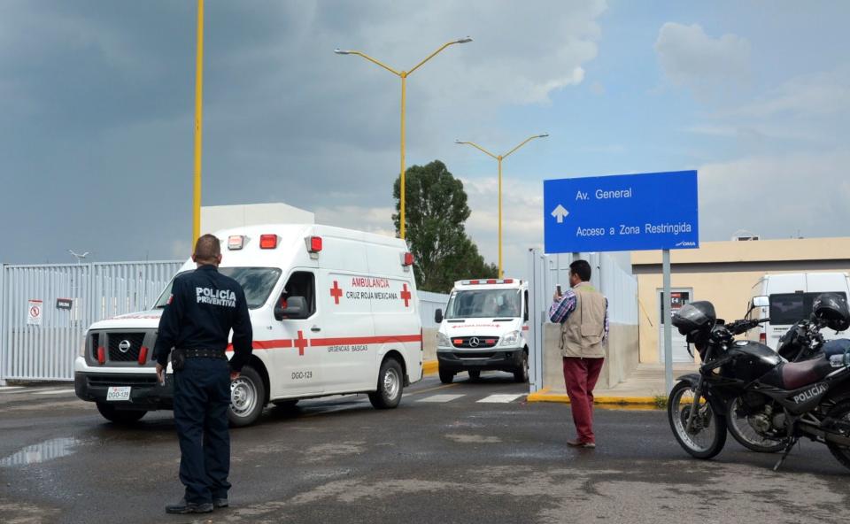 <p>Ambulances are seen at the airport of Durango, in northern Mexico, after a plane carrying 97 passengers and four crew crashed during take off on July 31, 2018. (Photo: Lulu Murillo/AFP/Getty Images) </p>