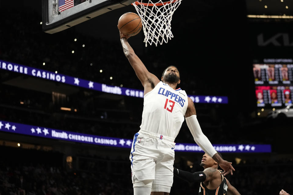 Los Angeles Clippers guard Paul George (13) scores against the Atlanta Hawks during the first half of an NBA basketball game Saturday, Jan. 28, 2023, in Atlanta. (AP Photo/John Bazemore)