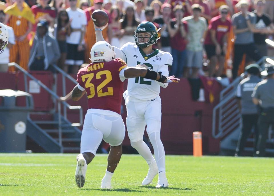 Baylor quarterback Blake Shapen (12) throws the ball over Iowa State Cyclones Gerry Vaughn (32) during the first quarter at Jack Trice Stadium on Saturday.