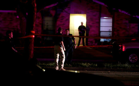 Police officers work the scene of a shooting at a home in Plano, north of Dallas, Texas - Credit: AP