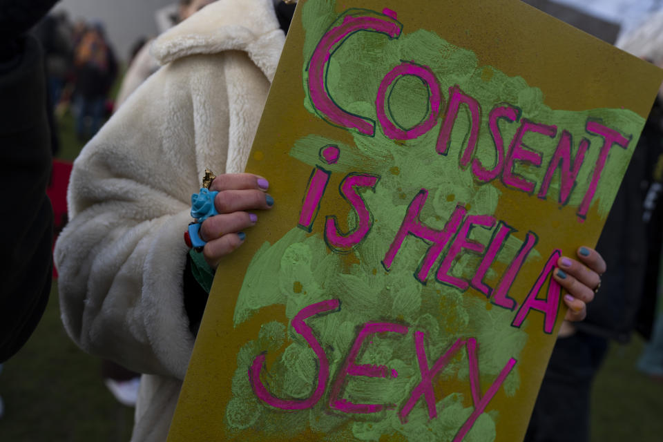 Hundreds of people protested in Amsterdam, Netherlands, Saturday, Jan. 29, 2022, in a #MeToo demonstration sparked by allegations of sexual improprieties linked to a popular Dutch TV talent show. The demonstration on Amsterdam's Museumplein square was organized following reports of inappropriate sexual behavior, ranging from WhatsApp messages to an allegation of rape, linked to "The Voice of Holland." (AP Photo/Peter Dejong)