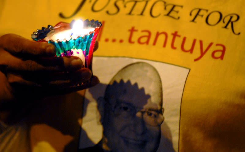 Demonstrator holds candle during vigil for release of Raja Petra and opposition member of parliament Kok in Kuala Lumpur