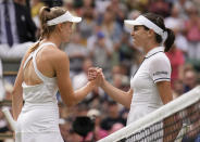 Australia's Ajla Tomljanovic, right, congratulates Kazakhstan's Elena Rybakina, after being defeated by her in a women's singles quarterfinal match on day ten of the Wimbledon tennis championships in London, Wednesday, July 6, 2022. (AP Photo/Alberto Pezzali)