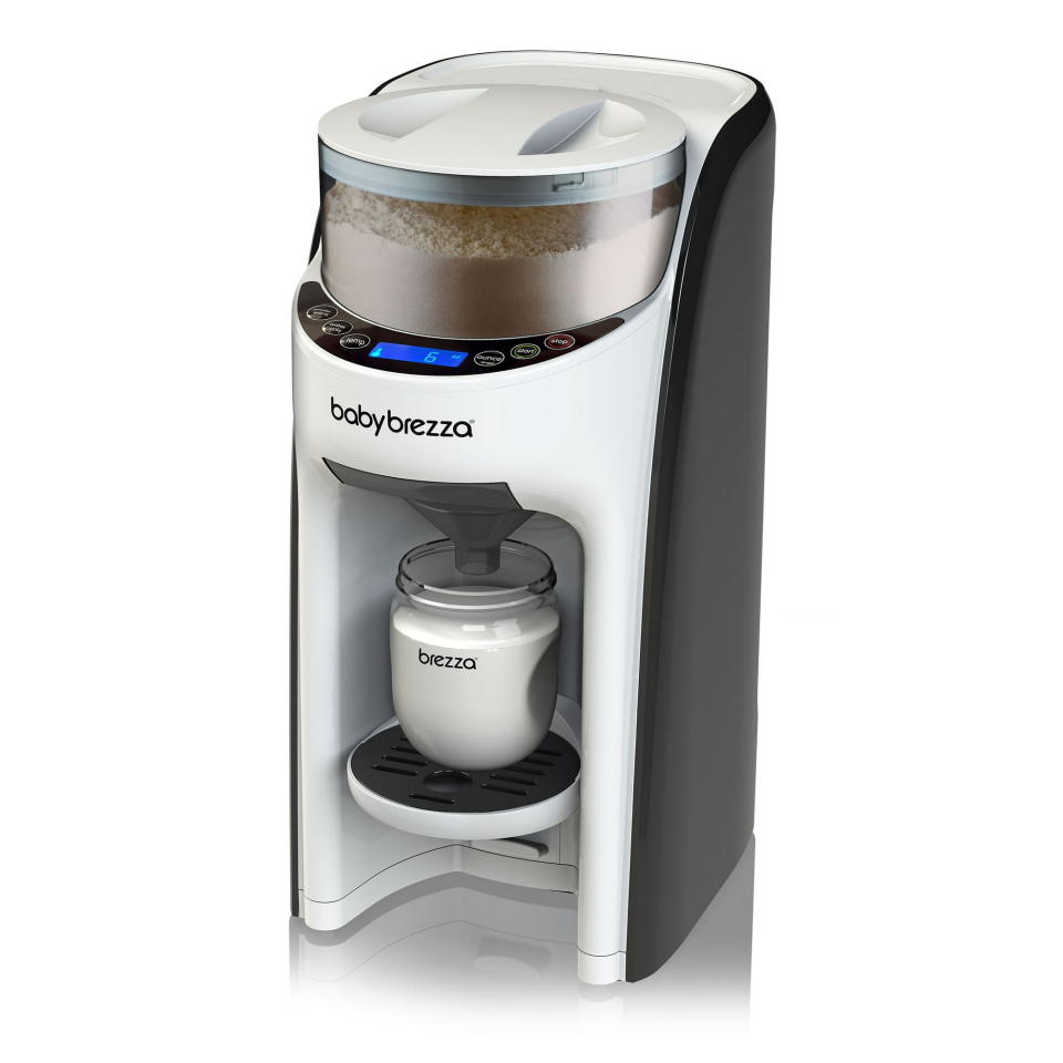 A machine similar to a coffee pod machine that contains powdered baby formula up top to mix with warm water to make a baby bottle.