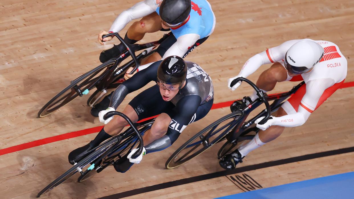  Three cyclist sprint to the finish on a wooden oval track at the Track World Championships  