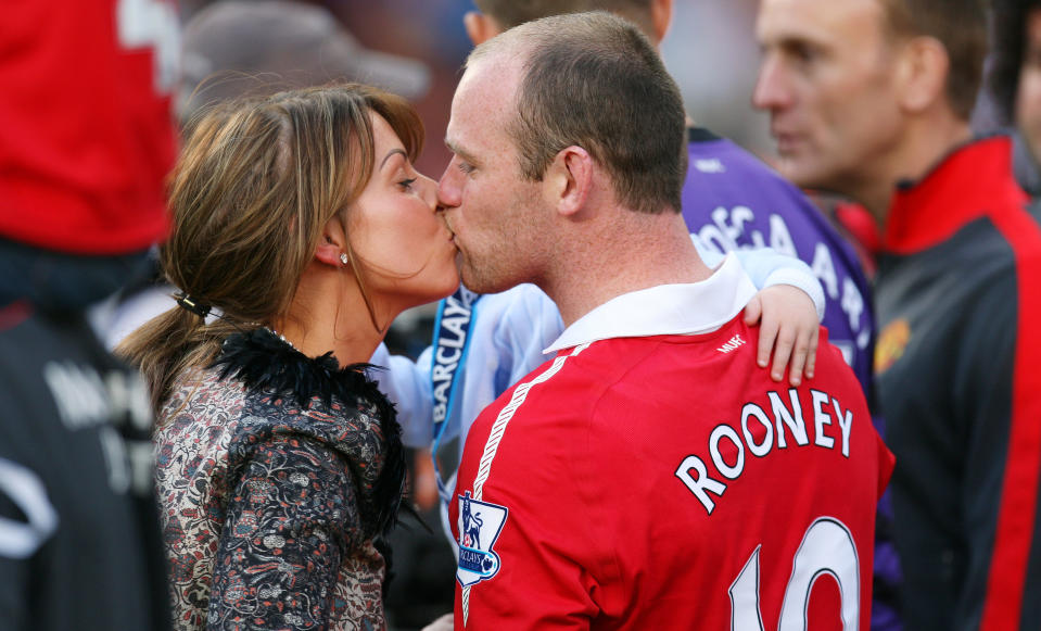 Football - Manchester United v Blackpool Barclays Premier League - Old Trafford - 10/11 - 22/5/11 
Manchester United celebrate winning the Premier League as Wayne Rooney and his wife Coleen kiss after the match 
Mandatory Credit: Action Images / Carl Recine 
Livepic 
NO ONLINE/INTERNET USE WITHOUT A LICENCE FROM THE FOOTBALL DATA CO LTD. FOR LICENCE ENQUIRIES PLEASE TELEPHONE +44 (0) 207 864 9000.