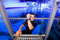 <p>Bear Grylls takes a dip in the tank filled with sharks, rays and tropical fish at The Bear Grylls Adventure in Birmingham, England, on Saturday.</p>