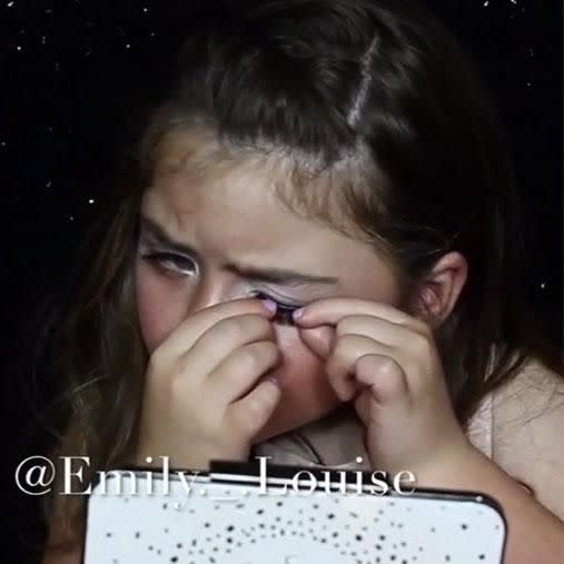 Bella Rose is seen putting on false eyelashes during the video. Photo: Instagram/emily._.louise