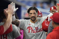 Philadelphia Phillies' Nick Castellanos celebrates with teammates after he a home run scoring Alec Bohm and Bryce Harper during the first inning of a baseball game against the Miami Marlins, Sunday, May 12, 2024, in Miami. (AP Photo/Wilfredo Lee)