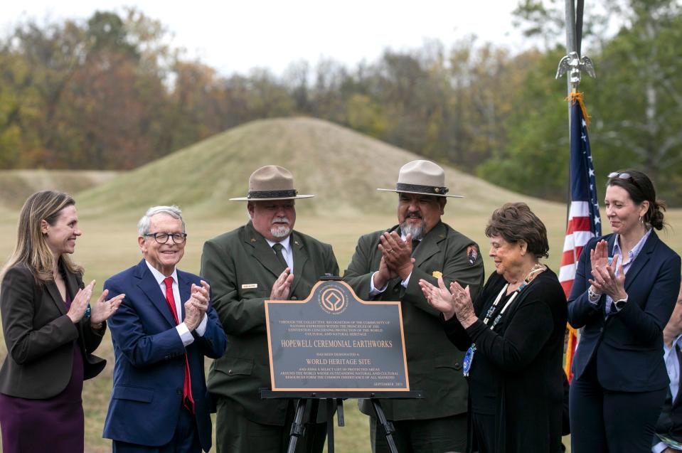 A panel of guest speakers applaud as the as a plaque is unveiled celebrating the Hopewell Ceremonial Earthworks a World Heritage Site during the Hopewell Ceremonial Earthworks UNESCO World Heritage Inscription on October 14, 2023, in Chillicothe, Ohio.