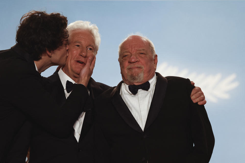 US actor Homer James Jigme Gere (L) kisses his father US actor Richard Gere (C) next to US director Paul Schrader (R) after the screening of the film 