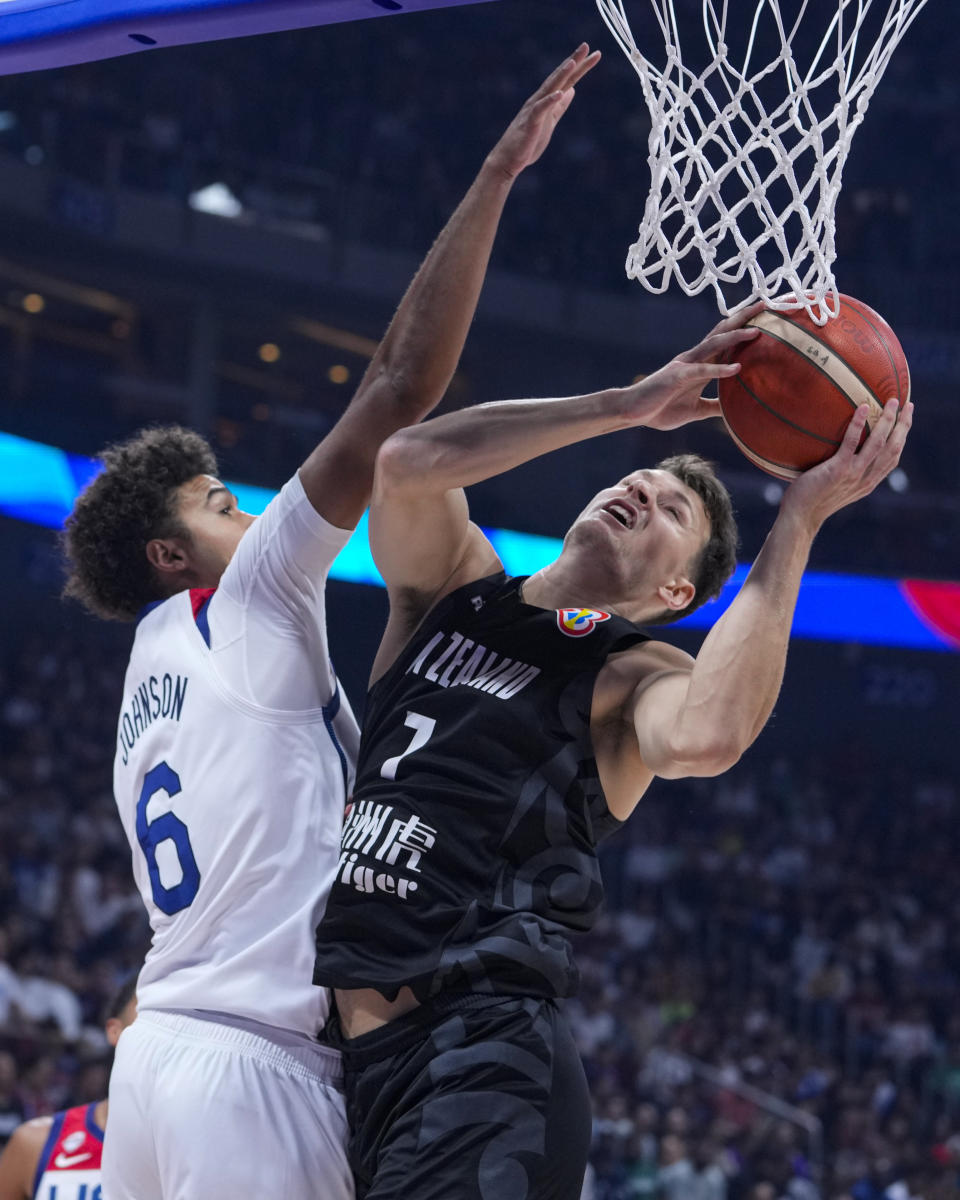 New Zealand forward Yannick Wetzell (7) shoots over U.S. forward Cameron Johnson (6) during the first half of a Basketball World Cup group C match in Manila, Saturday, Aug. 26, 2023. (AP Photo/Michael Conroy)