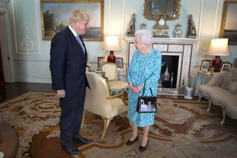 The Queen – with her Dyson fan in the background – with Boris Johnson in 2019 (Victoria Jones/PA) (PA Wire)