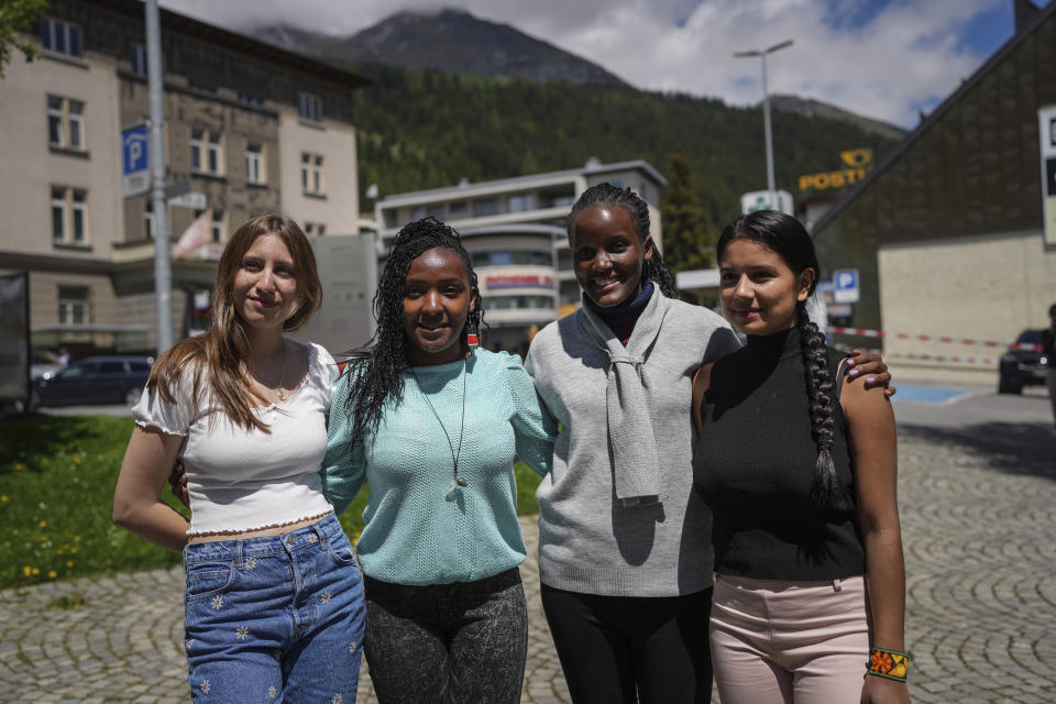 Climate activists Alexandria Villasenor of the United States, Elizabeth Wathuti of Kenia, Vanessa Nakate of Uganda and Helena Gualinga of Ecuador pose from left to right during a climate protest alongside the World Economic Forum in Davos, Switzerland, Thursday, May 26, 2022. The annual meeting of the World Economic Forum is taking place in Davos from May 22 until May 26, 2022. (AP Photo/Evgeniy Maloletka)