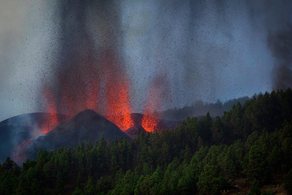 Lava flows from an eruption of a volcano at the island of La Palma in the Canaries, Spain, Sunday, Sept. 19, 2021. A volcano on Spain's Atlantic Ocean island of La Palma erupted Sunday after a weeklong buildup of seismic activity, prompting authorities to evacuate thousands as lava flows destroyed isolated houses and threatened to reach the coast. New eruptions continued into the night.