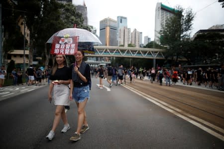 Anti-extradition bill protesters take part in the march to demand democracy and political reforms in Hong Kong