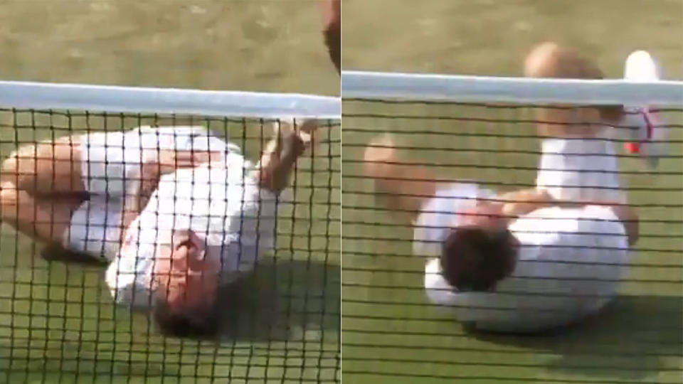 Bjorkman rolls around in agony. Pic: Twitter/Wimbledon