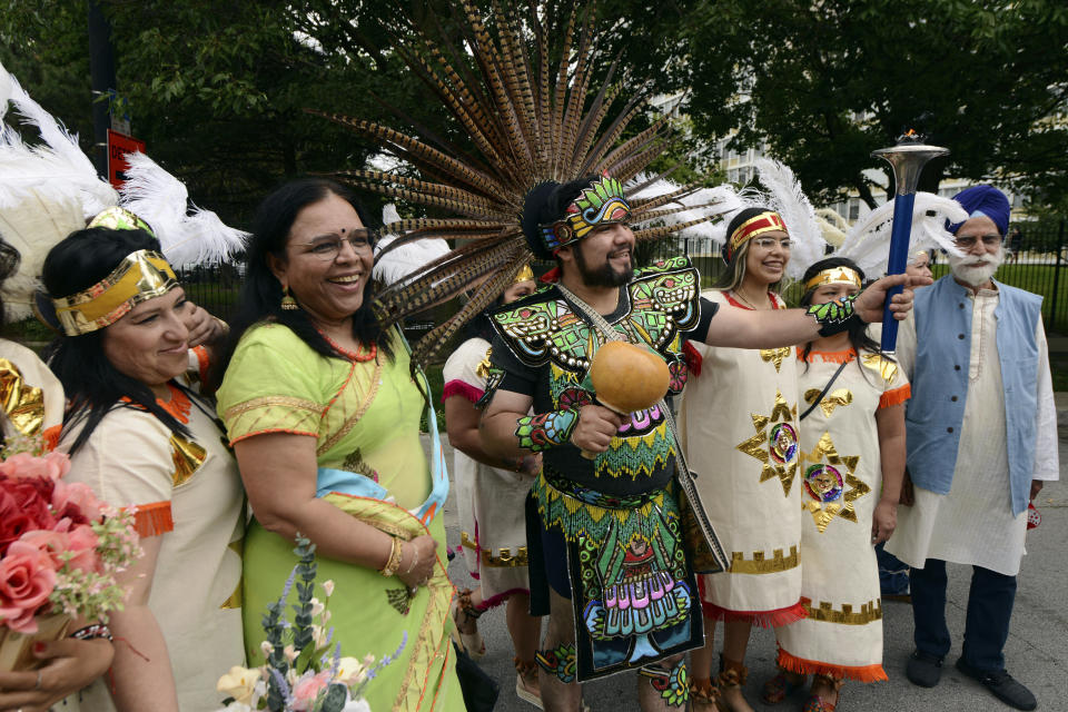 Members of the Cristo Rey Parish, Jain and Sikh community pose before the Parliament of World Religion Parade of Faiths, Sunday, Aug. 13, 2023, in Chicago. (AP Photo/Paul Beaty)