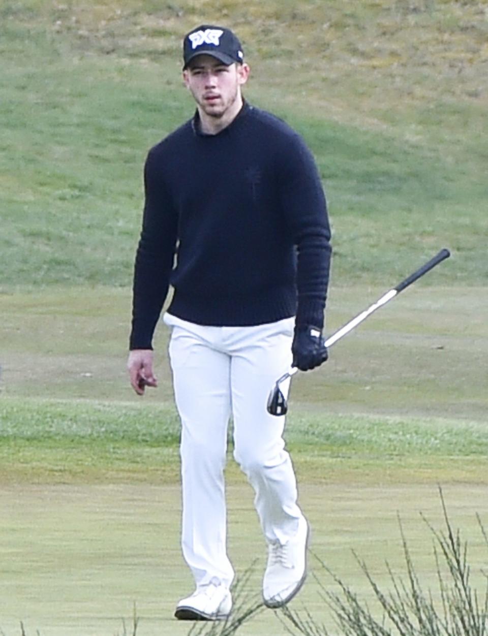 <p>Nick Jonas enjoys a cigar while out playing golf with a friend on Tuesday in Surrey, England.</p>