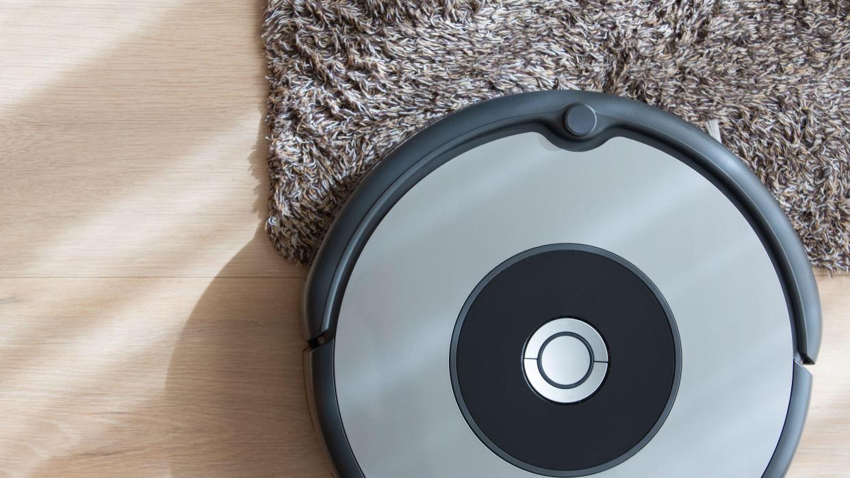  Robot vacuum cleaner on floor and carpet. 