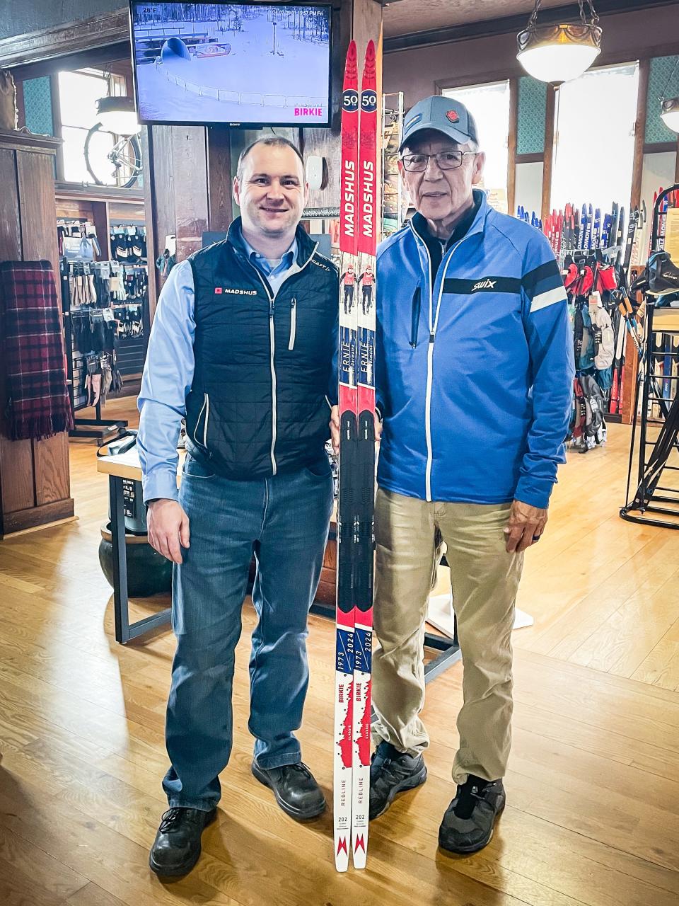 Ernie St. Germaine, right, is presented with a pair of custom skis commemorating his 50th Birkebeiner by Madshus representative Ben Dubay on at Riverbrook Bike & Ski in Hayward.