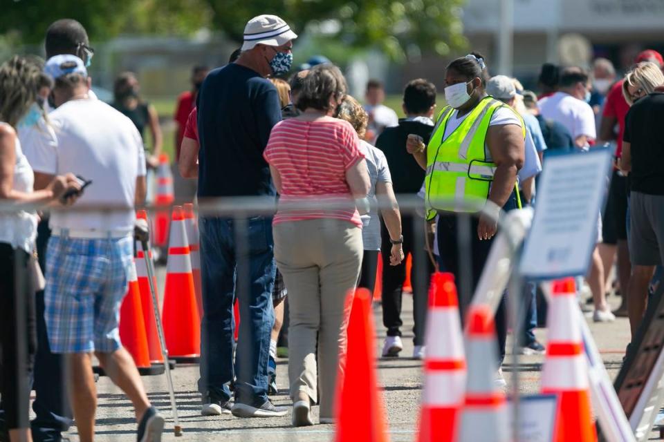 People line up to receive a COVID-19 vaccine at the Miami Dade College North vaccination site in Miami, Florida on Sunday, March 7, 2021.