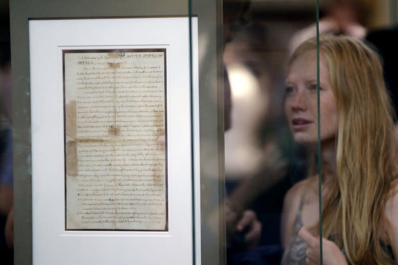 A woman looks at a rare historic copy of the Declaration of Independence written in Thomas Jefferson's hand at the New York Public Library in New York City on July 3, 2014. On August 2, 1776, the Declaration of Independence, adopted on July 4, was signed by members of the Continental Congress. File Photo by John Angelillo/UPI