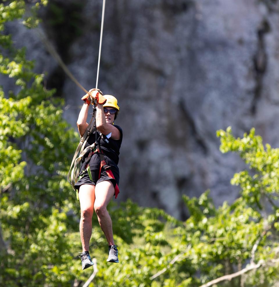 Susan Row, 70, from Leland, North Carolina, celebrates her birthday by zip lining with her family. Patrons were ziplining, horseback riding and panning for stones at the Canyons Zip Line and Adventures Park on June 17.