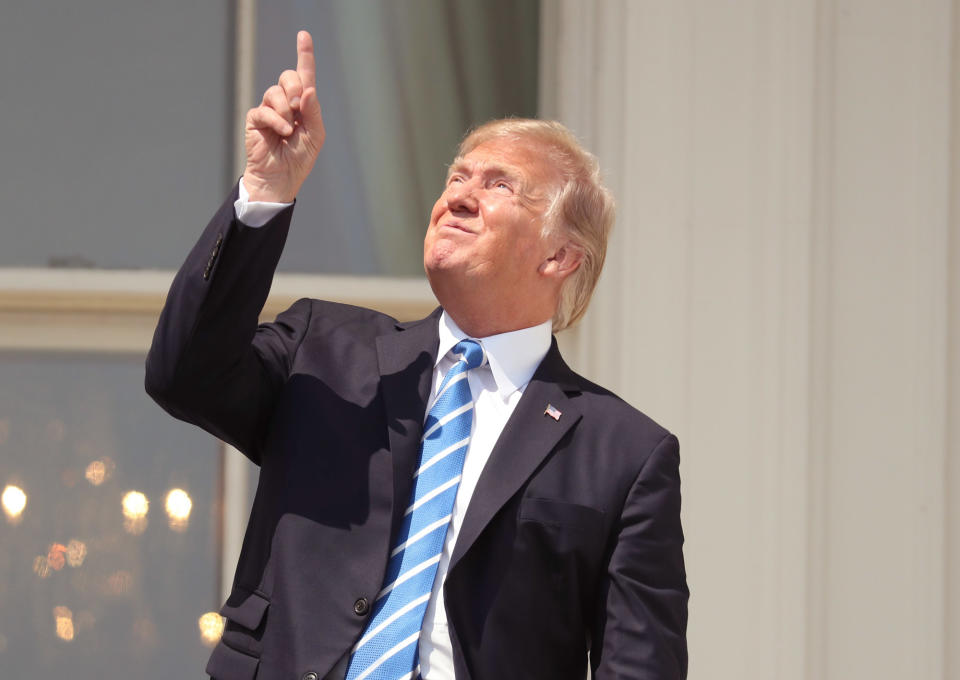 <p>President Donald Trump stares at the sky on Aug. 21, 2017, while watching the total solar eclipse in Washington, D.C.</p> <p><a href="https://people.com/tag/donald-trump" rel="nofollow noopener" target="_blank" data-ylk="slk:Trump;elm:context_link;itc:0;sec:content-canvas" class="link ">Trump</a> made the <a href="https://people.com/politics/president-trump-melania-watch-total-solar-eclipse-white-house/" rel="nofollow noopener" target="_blank" data-ylk="slk:same mistake;elm:context_link;itc:0;sec:content-canvas" class="link ">same mistake</a> during the eclipse that scientists had been warning against for weeks: He looked directly into the sun without protective glasses. As Trump, First Lady <a href="https://people.com/tag/melania-trump" rel="nofollow noopener" target="_blank" data-ylk="slk:Melania Trump;elm:context_link;itc:0;sec:content-canvas" class="link ">Melania Trump</a> and their son Barron, then 11, emerged on the Truman Balcony of the White House, the president put on<a href="http://time.com/4878020/solar-eclipse-glasses-2017/" rel="nofollow noopener" target="_blank" data-ylk="slk:“eclipse glasses”;elm:context_link;itc:0;sec:content-canvas" class="link "> “eclipse glasses”</a>, then took them off and, for a brief moment, stared upwards at the sun. “As he did this, someone in a crowd of aides below shouted ‘Don’t look,’ ” according to the<i> Wall Street Journal</i>‘s Ted Mann, who posted a photo from the moment on Twitter.</p>