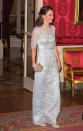 <p>Black tie dinners are always Kate’s time to shine. For such an occasion in Paris, the Duchess was spotted in a gorgeous bespoke Jenny Packham gown. The silvery design featured sheer sleeves and beaded floral embellishing. A glittering clutch (also by Jenny Packham) was carried with sparkly Oscar de la Renta pumps topping off the princess-worthy ensemble. </p><p><i>[Photo: PA]</i> </p>