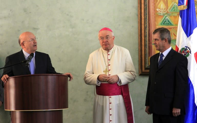 Then Vatican nuncio Josef Wesolowski (C), pictured with Dominican Foreign Minister Carlos Morales Troncoso (L) and Colombian ambassador to the Dominican Republic Mario Montoya (R) during a ceremony in Santo Somingo in 2011