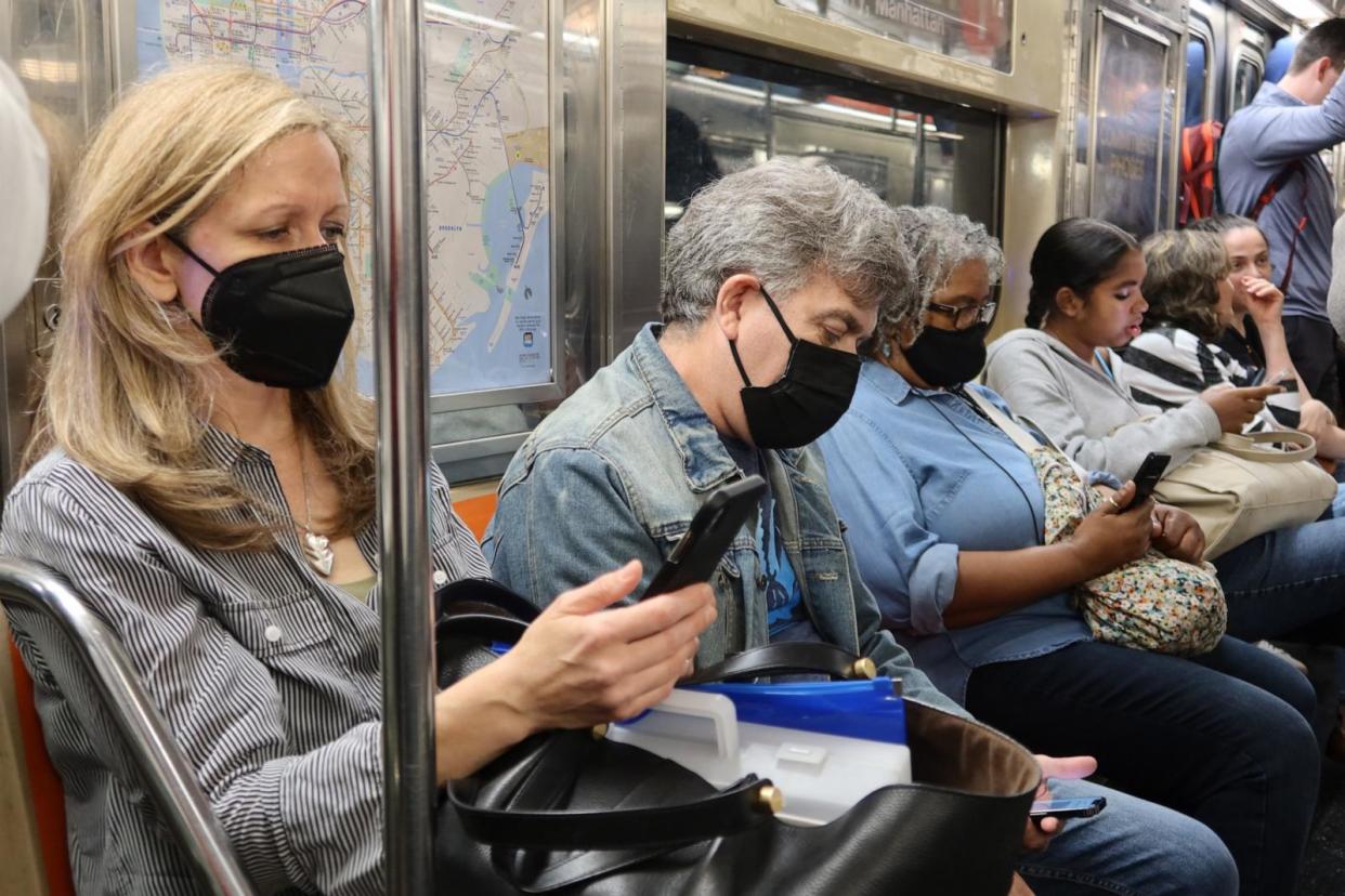 PHOTO: People wear face masks while riding on a subway train in New York City, June 7, 2023. (Gary Hershorn/ABC News)