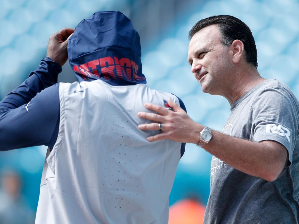 Agent Drew Rosenhaus speaks with Antonio Brown before a game against the Miami Dolphins.