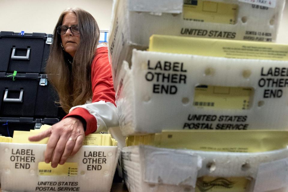Becky White, a Mesa County election specialist, lifts a box of ballots cast during the midterm election on Nov. 8, 2022, in Grand Junction, Colo. <a href="https://media.gettyimages.com/id/1244617244/photo/us-vote-election-colorado.jpg?s=612x612&w=gi&k=20&c=gkk9fyO9C7rQZGlhkvGl0z_BMTrXS0NbuEqjIkWPcVU=" rel="nofollow noopener" target="_blank" data-ylk="slk:Jason Connolly/AFP via Getty Images;elm:context_link;itc:0;sec:content-canvas" class="link ">Jason Connolly/AFP via Getty Images</a>