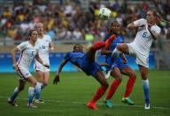 <p>France’s Kadidiatou Diani, center, fights for the ball with United States Whitney Engen during a group G match of the women’s Olympic football tournament between United States and France at the Mineirao stadium in Belo Horizonte, Brazil, Saturday, Aug. 6, 2016. (AP Photo/Eugenio Savio) </p>